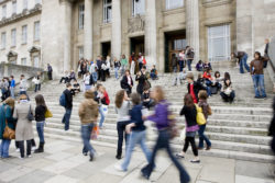 Students walk passed the Parkinson building out of focus