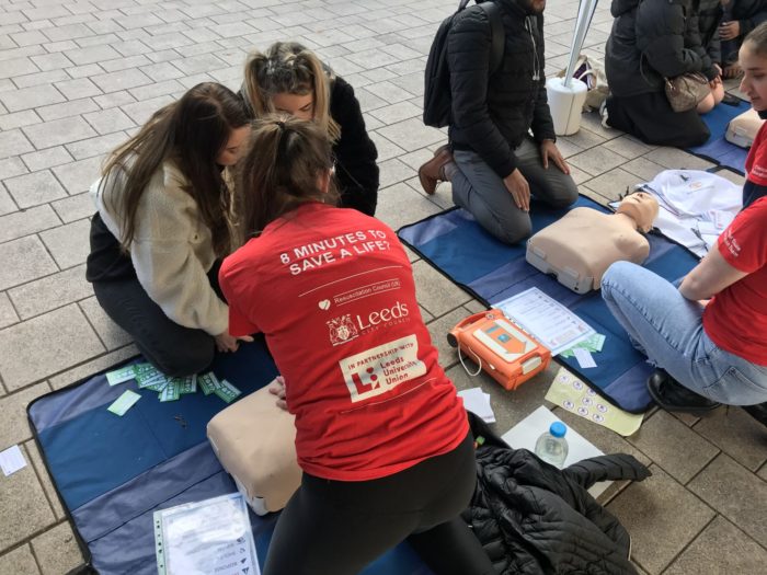 Students trained to give CPR carrying out training in Leeds city centre